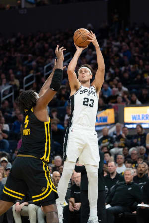 November 24, 2023; San Francisco, California, USA; San Antonio Spurs forward Zach Collins (23) shoots the basketball against Golden State Warriors forward Kevon Looney (5) during the second quarter at Chase Center.